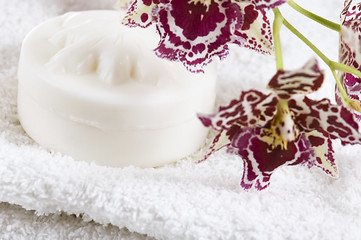 Image showing Spa items with white towels, natural soap and orchid