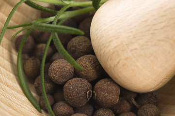 Image showing Mortar with fresh herbs and allspice berries