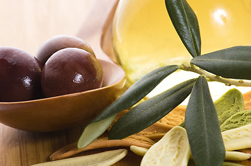 Image showing pasta, black olives, oil with fresh branch. food ingredients 