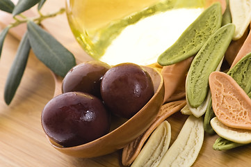 Image showing pasta, black olives, oil with fresh branch. food ingredients 