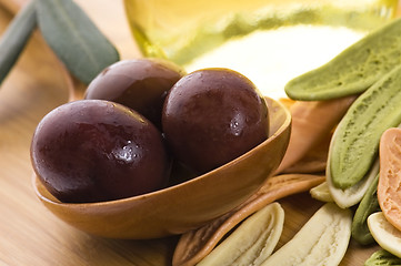 Image showing pasta, black olives, oil with fresh branch. food ingredients 