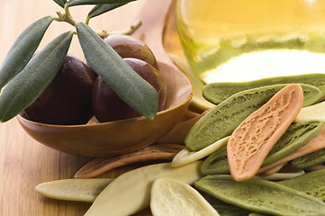 Image showing pasta, black olives, oil with fresh branch. food ingredients 