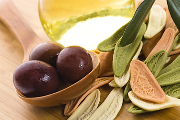 Image showing pasta, black olives, oil with fresh branch. food ingredients 