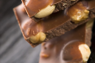 Image showing Pile of broken chocolate with nuts