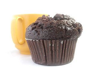 Image showing Chocolate muffin and yellow cup