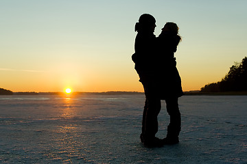 Image showing Silhouette of a couple hugging on ice