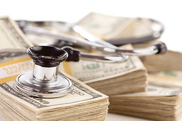 Image showing Stethoscope Laying on Stacks of Money