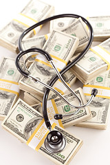 Image showing Question Mark Shaped Stethoscope Laying on Money