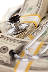 Image showing Stethoscope Laying on Stacks of Money