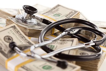 Image showing Stethoscope Laying on Stacks of Money