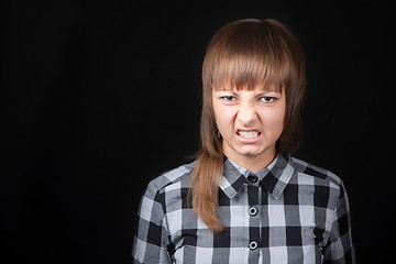 Image showing Young beautiful girl snarls