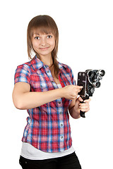 Image showing Girl in plaid shirt with charges movie camera