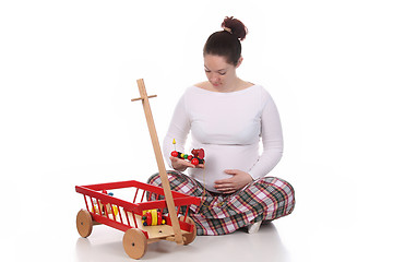 Image showing pregnant woman and toys 