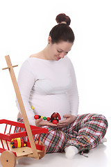 Image showing pregnant woman and toys 