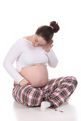 Image showing pregnant woman listening