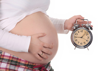 Image showing pregnant woman with alarm clock waiting 