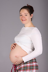 Image showing pregnant woman holding belly