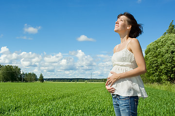 Image showing Pregnant woman smiling on field