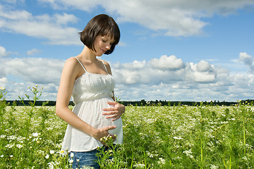 Image showing Pregnant woman smiling on a field