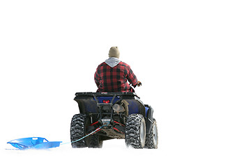 Image showing ATV on snow pulling sled