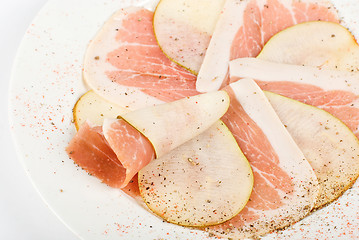 Image showing Sliced bacon with sliced pear
