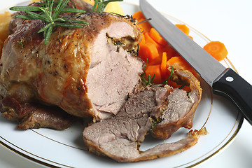 Image showing Joint of lamb with carving knife