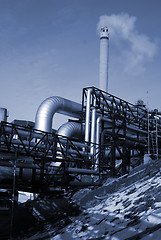 Image showing industrial pipelines on pipe-bridge against blue sky