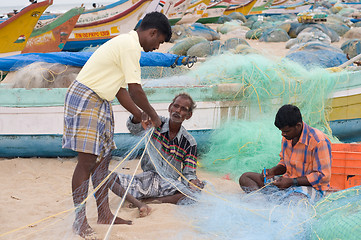 Image showing Fisherman weaving nets in the Indian coastline