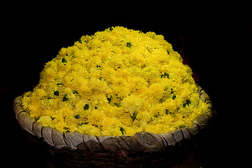 Image showing basket full of yellow flowers at a local flower market