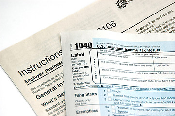 Image showing Hand signing a tax form concept of filing tax