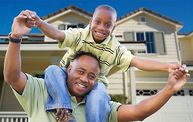 Image showing Playful Father and Son In Front of Home