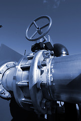 Image showing  Pipes, bolts, valves against blue sky in blue tones