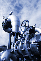 Image showing  Pipes, bolts, valves against blue sky in blue tones