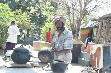 Image showing rasta man preparing food 320