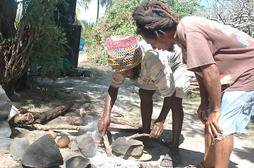 Image showing rasta men starting fire 328