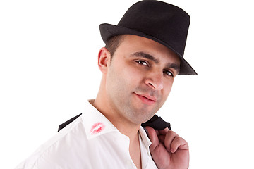 Image showing seductive man with his hat, the shirt with lipstick mark