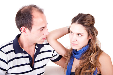 Image showing a couple looking for another, sitting on the couch