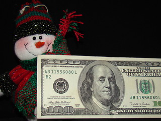 Image showing A snowman and his money.