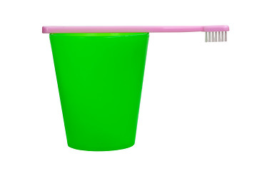 Image showing Pink toothbrush and green cup for children