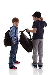 Image showing two students seen with his back to the school bags, one looking back