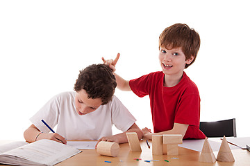 Image showing two students in the classroom, making ugly gestures