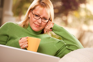 Image showing Beautiful Woman Enjoys Her Warm Drink and Laptop