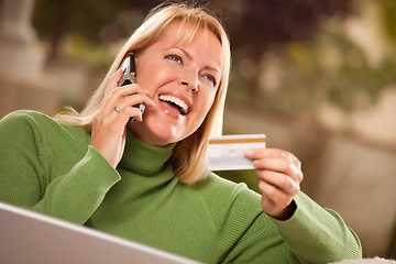 Image showing Cheerful Woman on Phone and Laptop with Credit Card