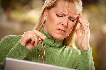 Image showing Grimacing Woman Suffering a Headache