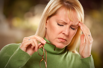 Image showing Grimacing Woman Suffering a Headache