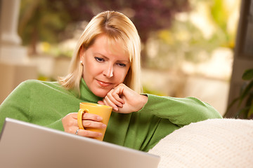 Image showing Beautiful Woman Enjoys Her Warm Drink and Laptop