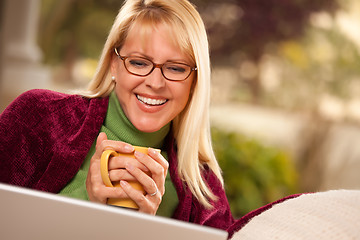 Image showing Beautiful Woman Enjoys Her Warm Drink and Laptop