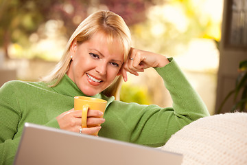 Image showing Beautiful Woman Enjoys Her Warm Drink and Laptop