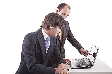 Image showing Two businessmen working together on a laptop