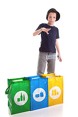 Image showing boy putting a plastic bottle to recycle